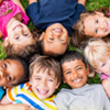 Group of multicultural children laying in the grass